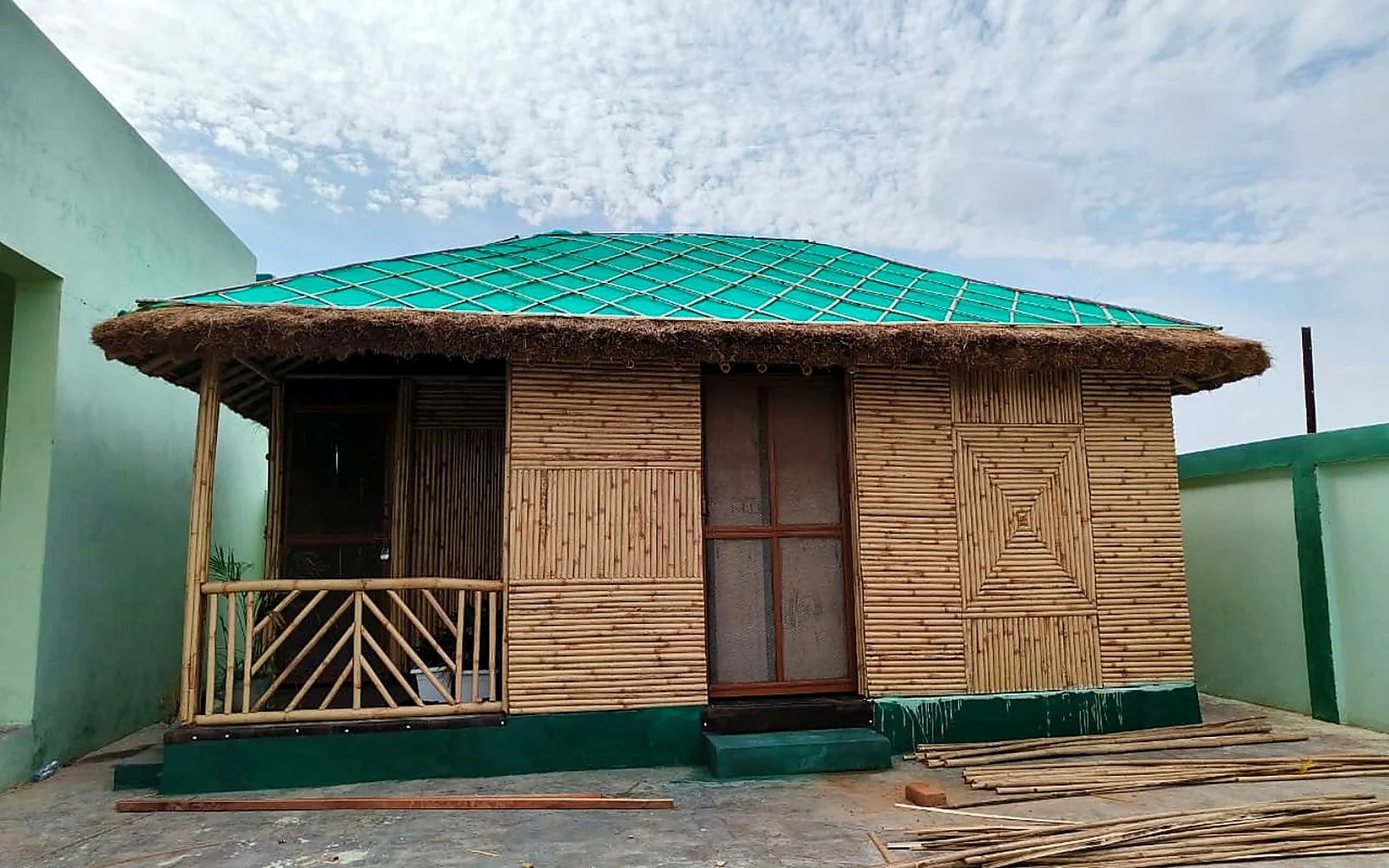 Custom bamboo dwelling with a covered porch and woven façade