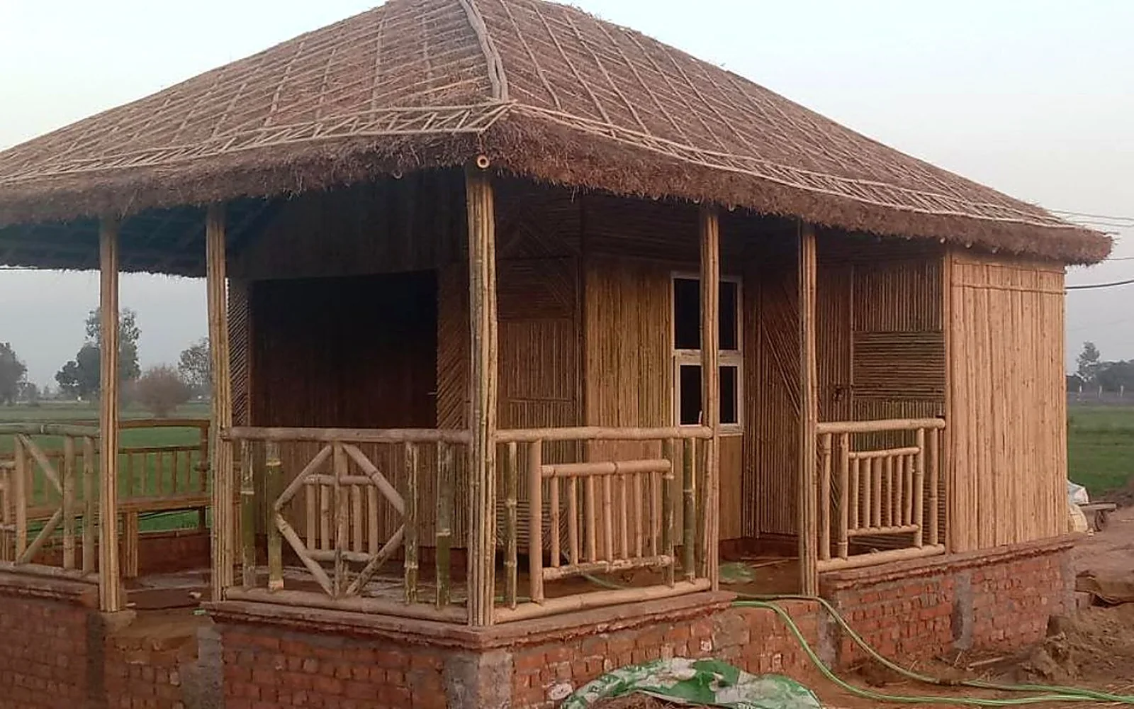 Thatched bamboo hut with an open porch and woven railings